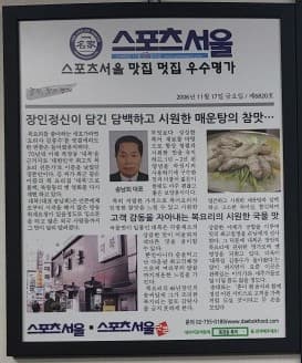 대복과 복요리 관련 기사를 담은 매장 스포츠서울 신문 액자